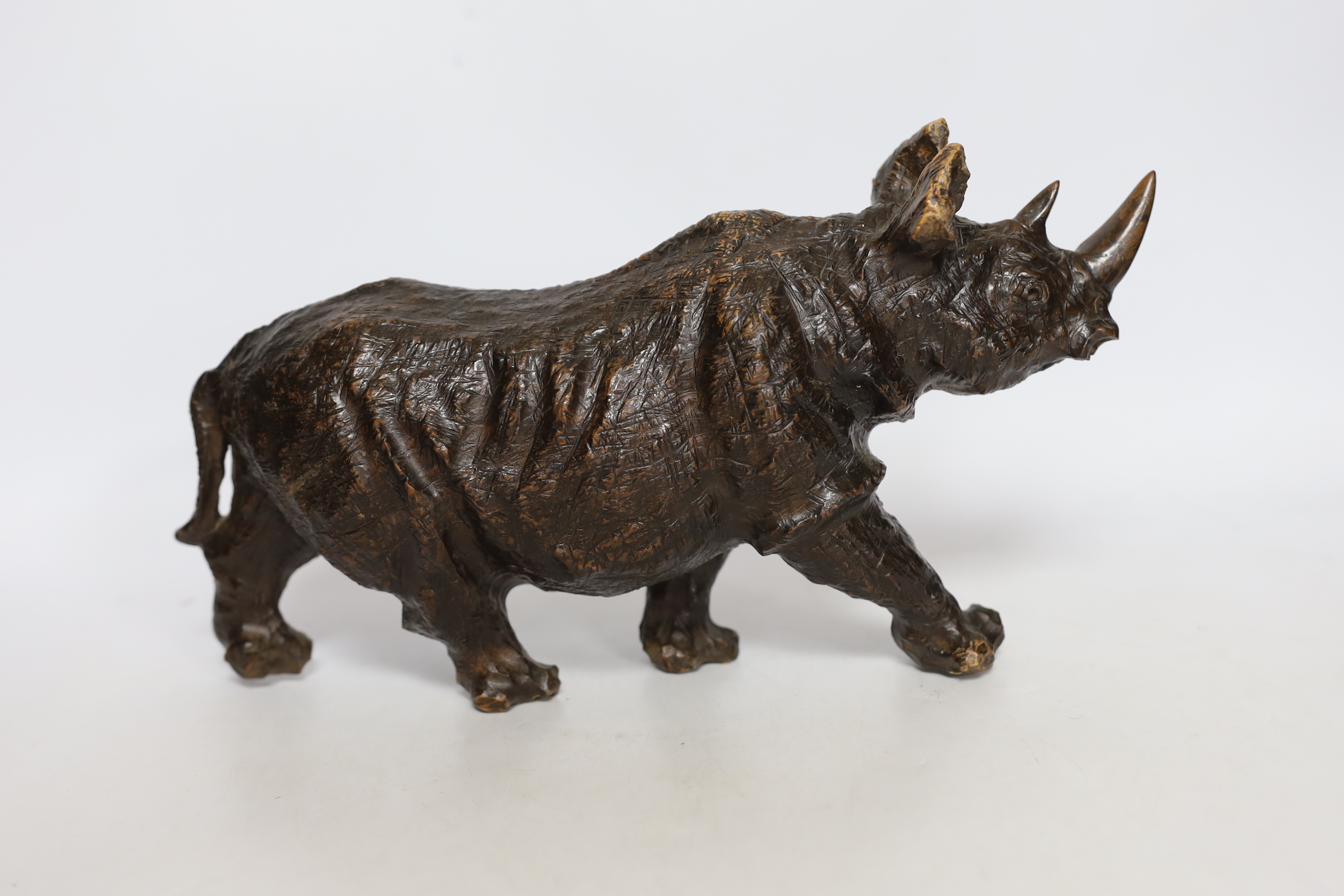 A carved heavy rootwood model of a rhinoceros, 33cm